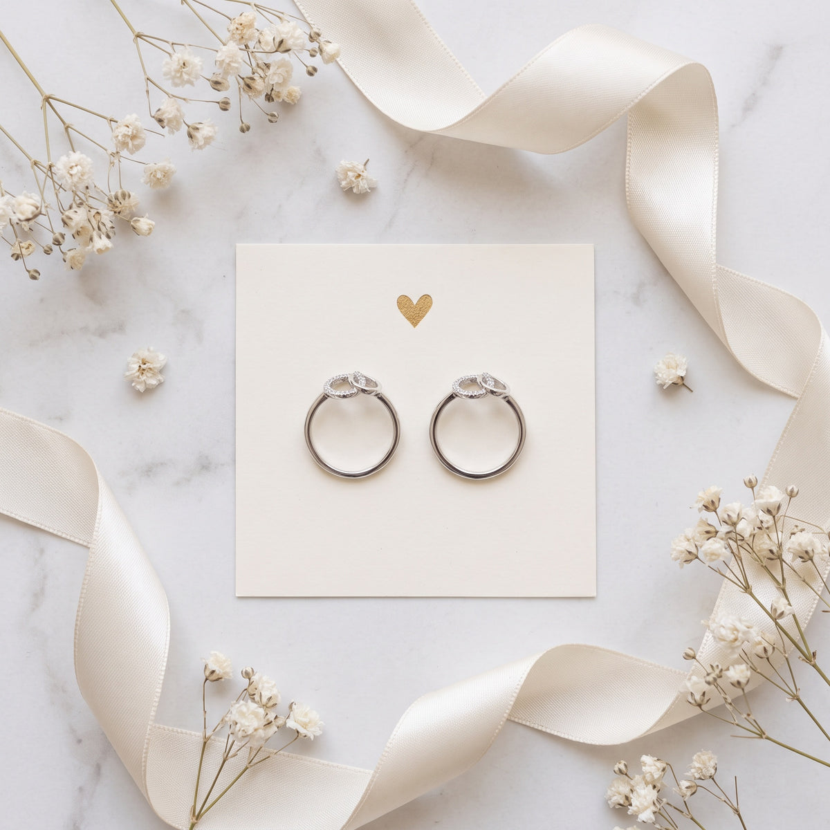A matching pair of sister rings on a keepsake card